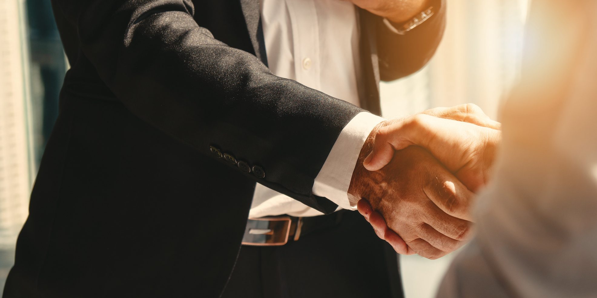 business background of businessman having handshake Consumer Brand Hiring: How to Attract Top Talent in Today's Competitive Market