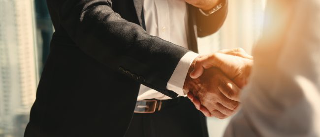 business background of businessman having handshake Consumer Brand Hiring: How to Attract Top Talent in Today's Competitive Market