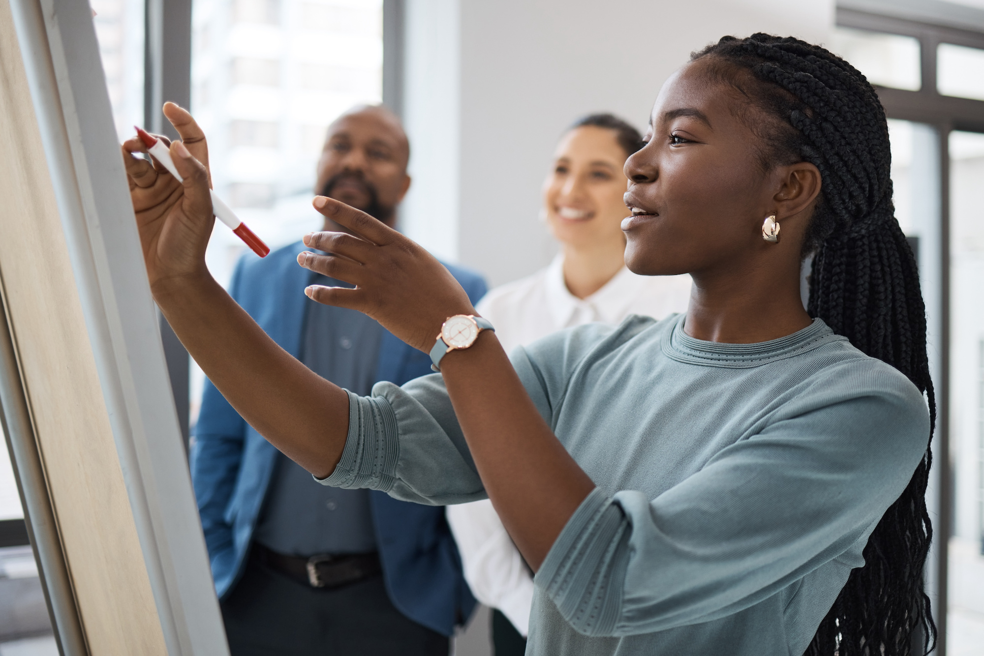 Black woman, business learning and whiteboard writing for company planning with strategy. African female employee, meeting and sales collaboration of staff working with teamwork and workshop idea Unlocking Top Talent in CPG: A Deep Dive into Retained & Contingent Searches with Hunter & Michaels