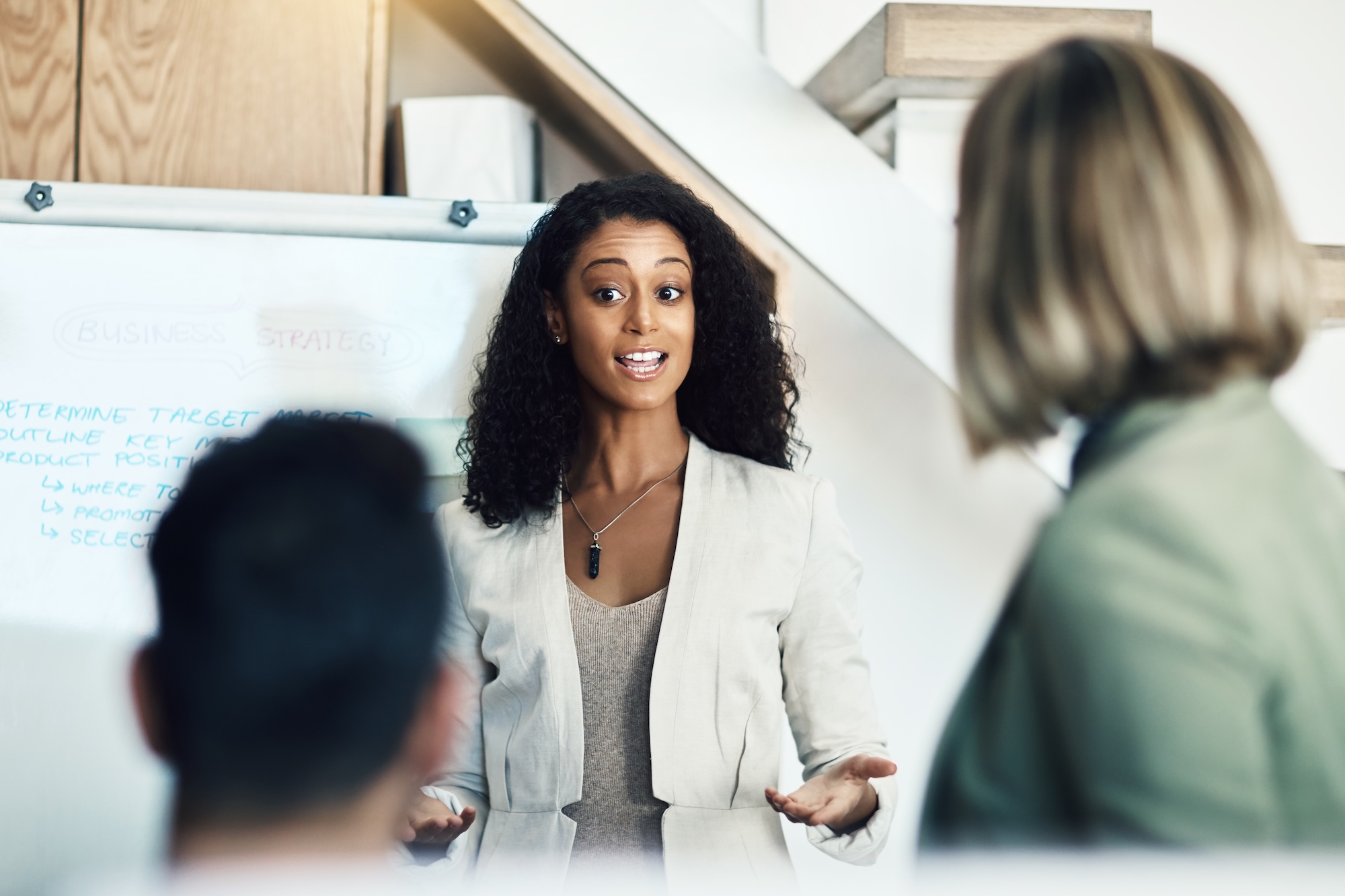 Presentation meeting, speaker and business woman talking, planning and giving proposal, report or strategy plan. Project management, communication and biracial manager with sales pitch ideas The Ultimate Guide to CPG Executive Hiring